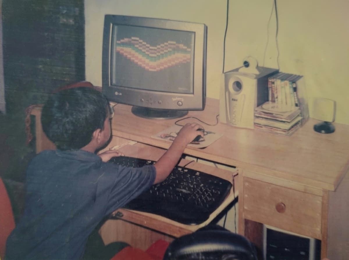 Vyshnav as a child in front of the family PC, Kannur, Kerala.